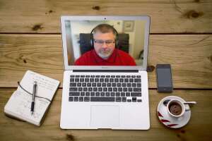 Video Counsellor Dean Richardson on a Macbook Air